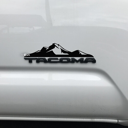 Etiqueta engomada de las montañas de Toyota Tacoma sobre la insignia Tacoma 3
